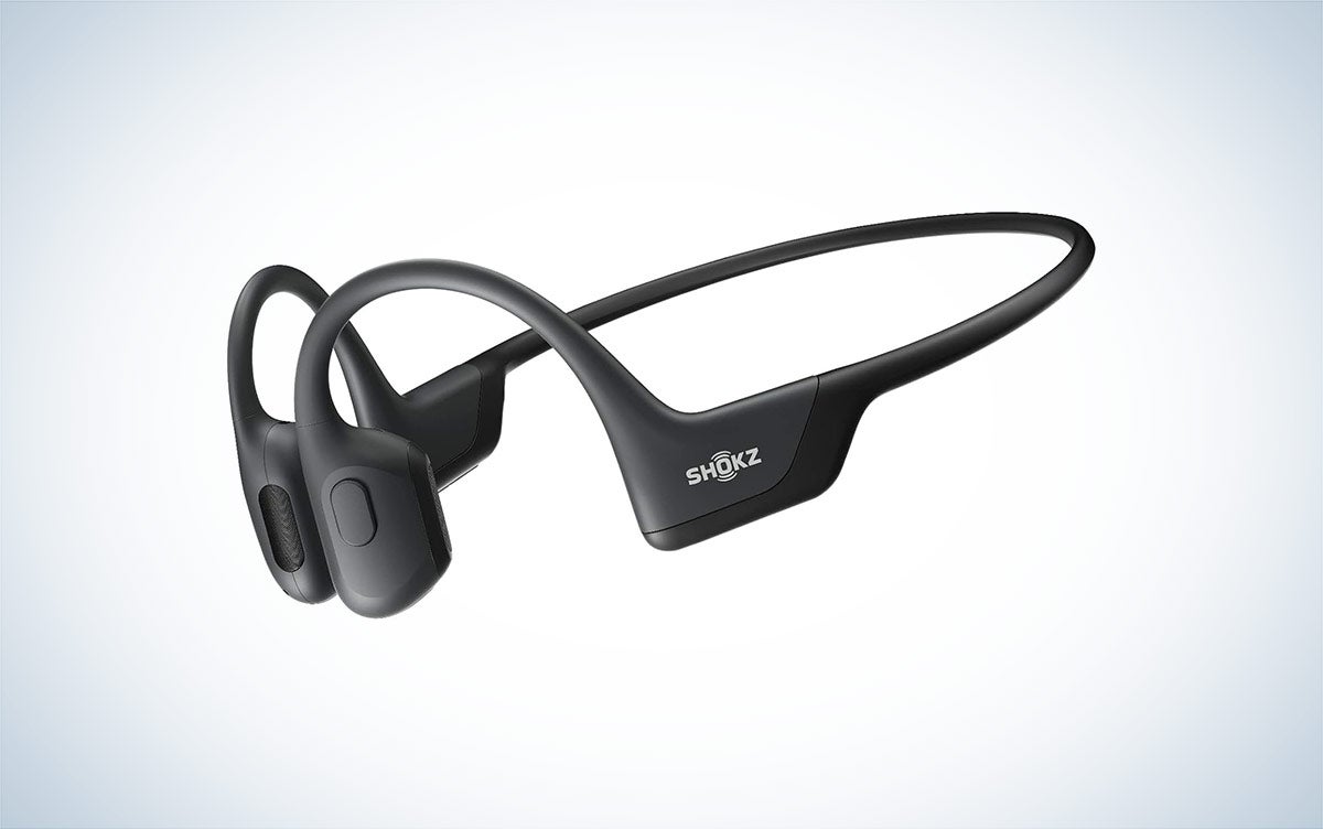 The Shokz OpenRun Pro bone-conduction headphones are placed against a white background with a gray gradient.