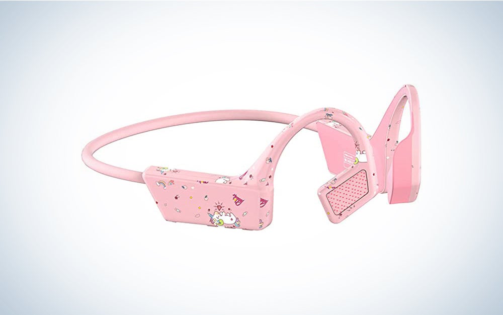 A pair of pink bone conduction headphones with a unicorn pattern on a blue and white background
