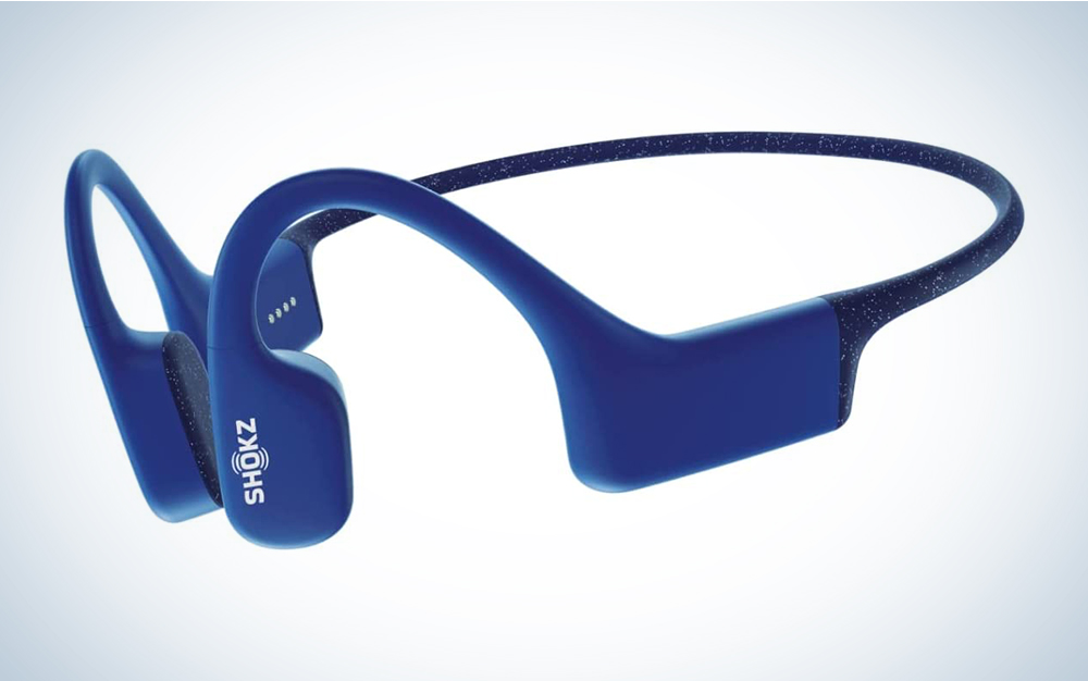 A pair of blue bone conduction headphones on a blue and white background