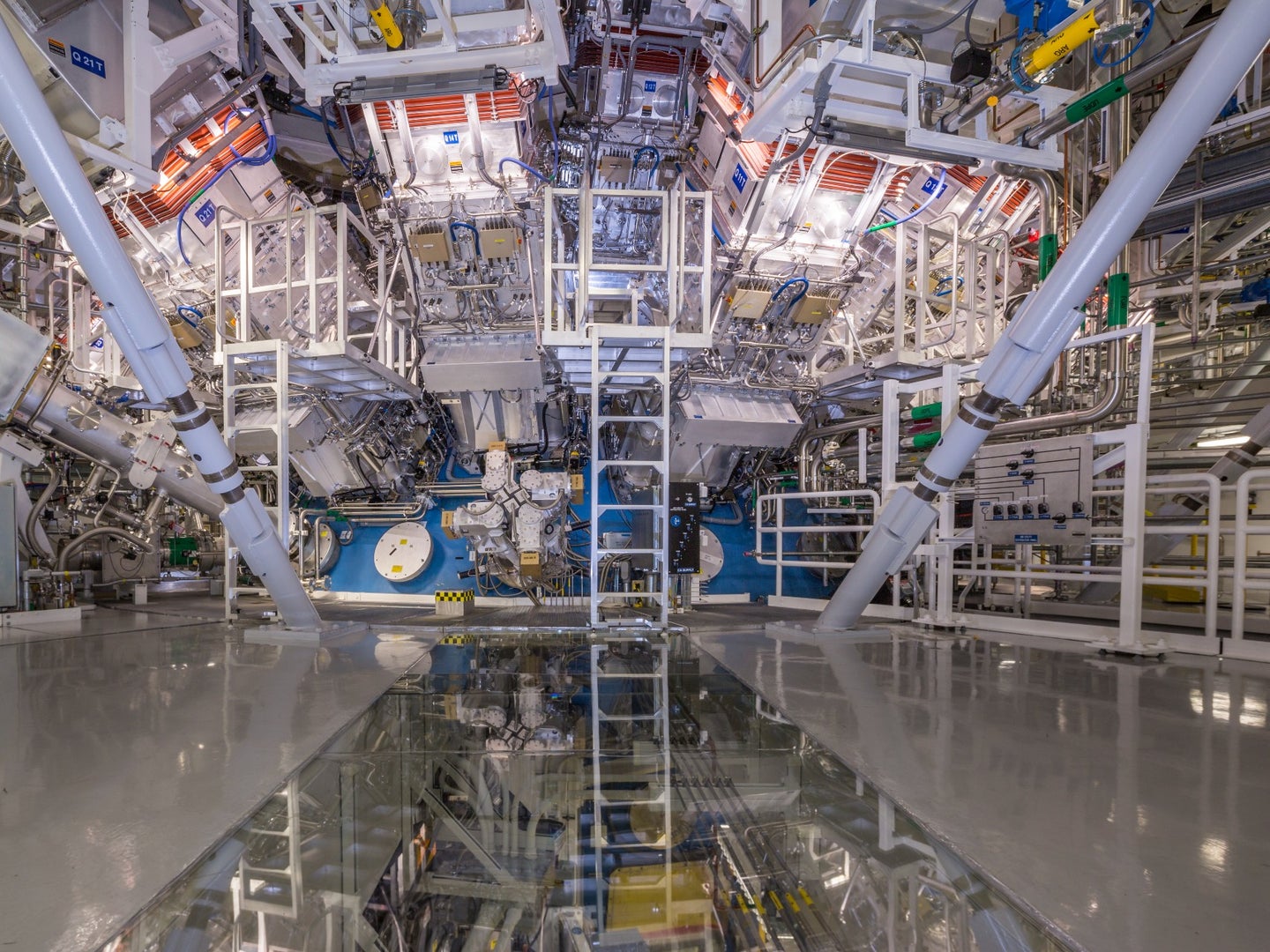 A science lab with a nuclear fusion reactor in the background, and a ladder leading to the center.