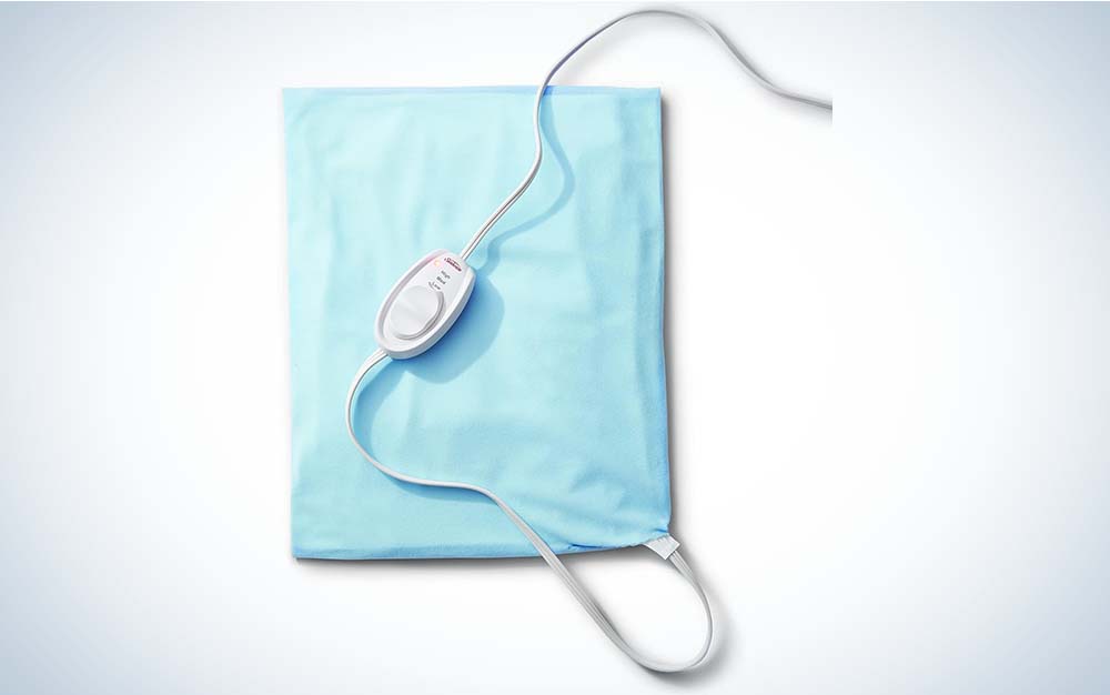 A light blue heating pad made by Sunbeam attached to a gray cord and controller.
