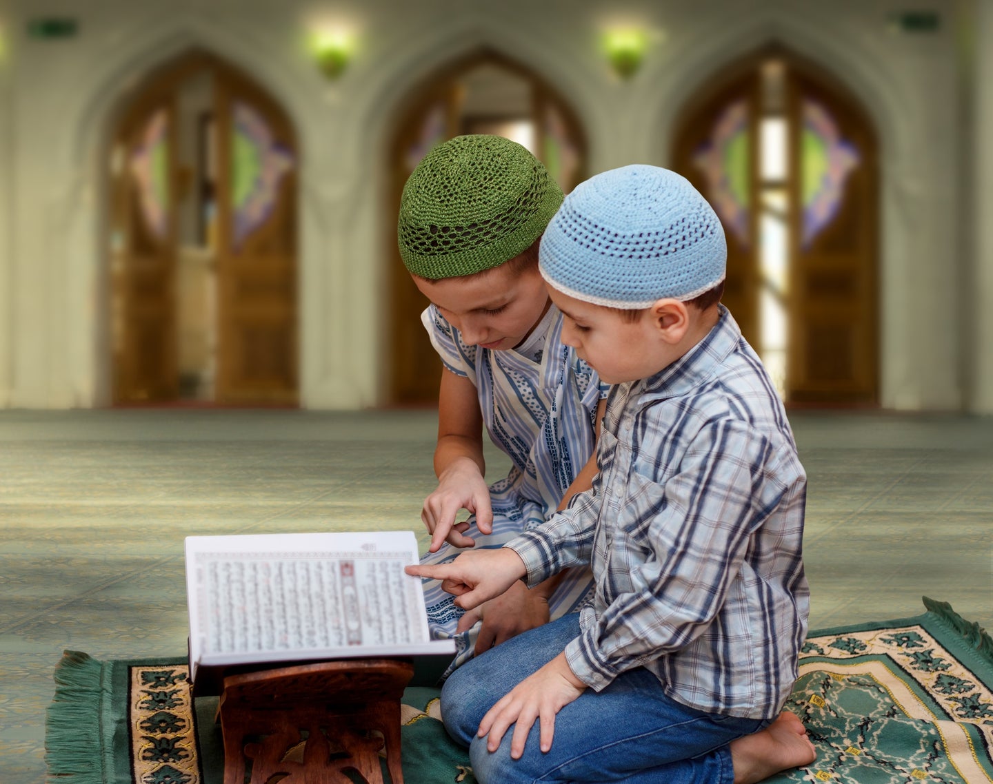 Muslim family reading Quran in mosque