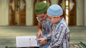 Muslim family reading Quran in mosque