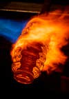 a flaming honeycomb-shaped piece of molten glass