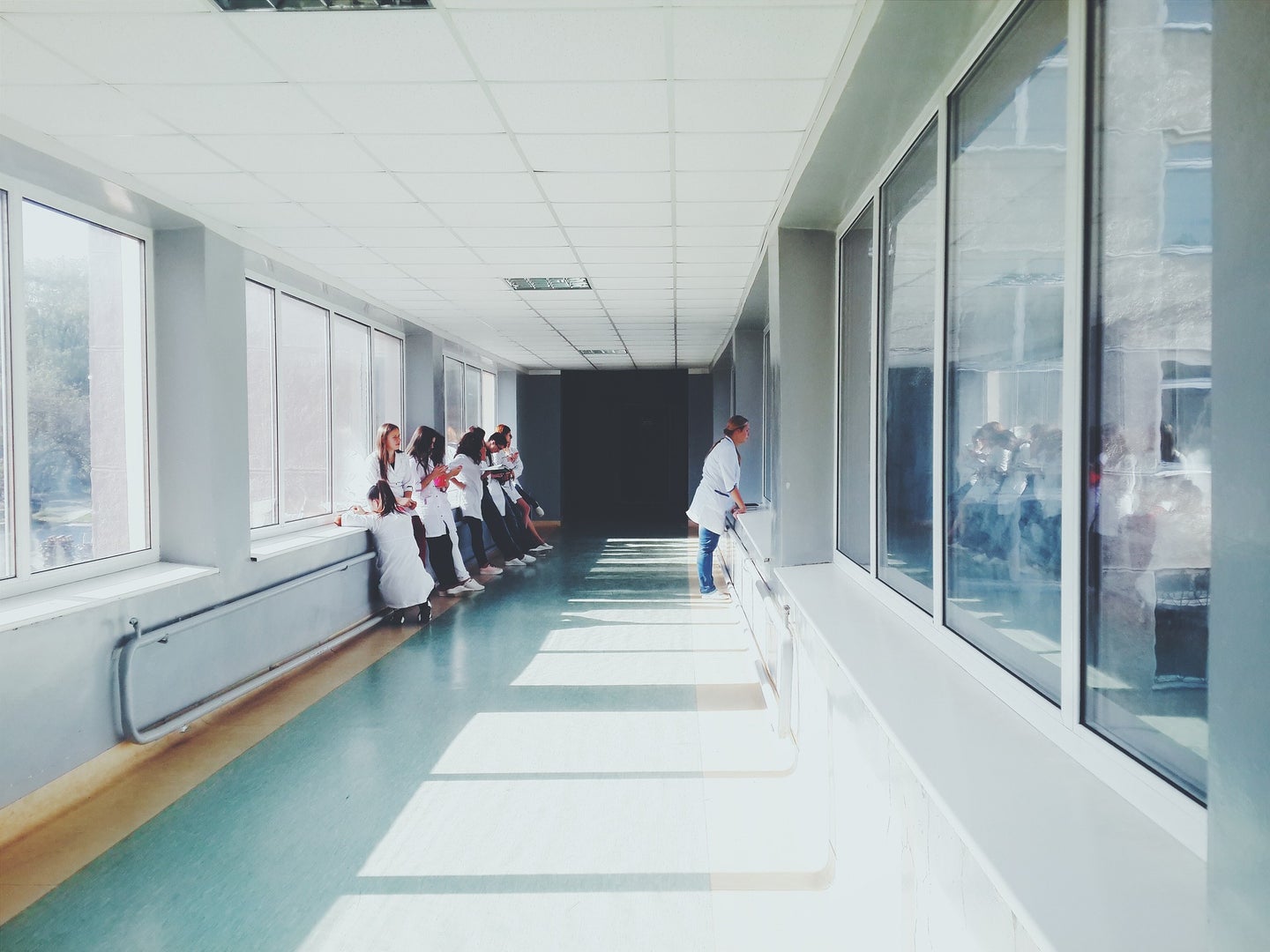 people standing in medical center hallway
