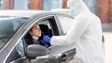 person in car gets covid nose swab test
