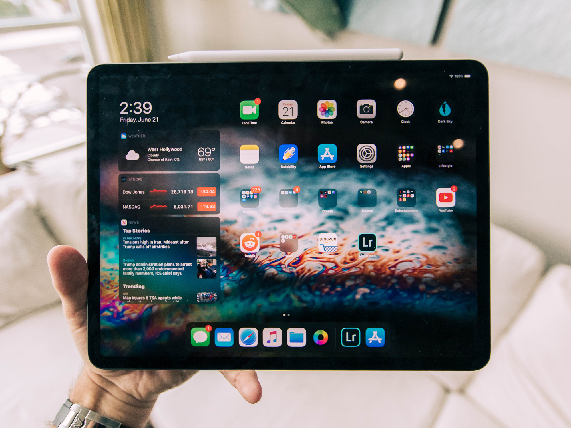 Hand holding an iPad pro with iPadOS 15