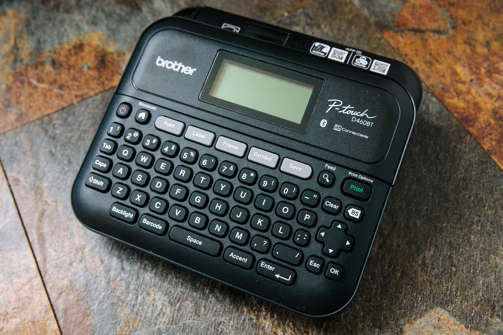 Brother PTouch 460bt label printer on a tile background