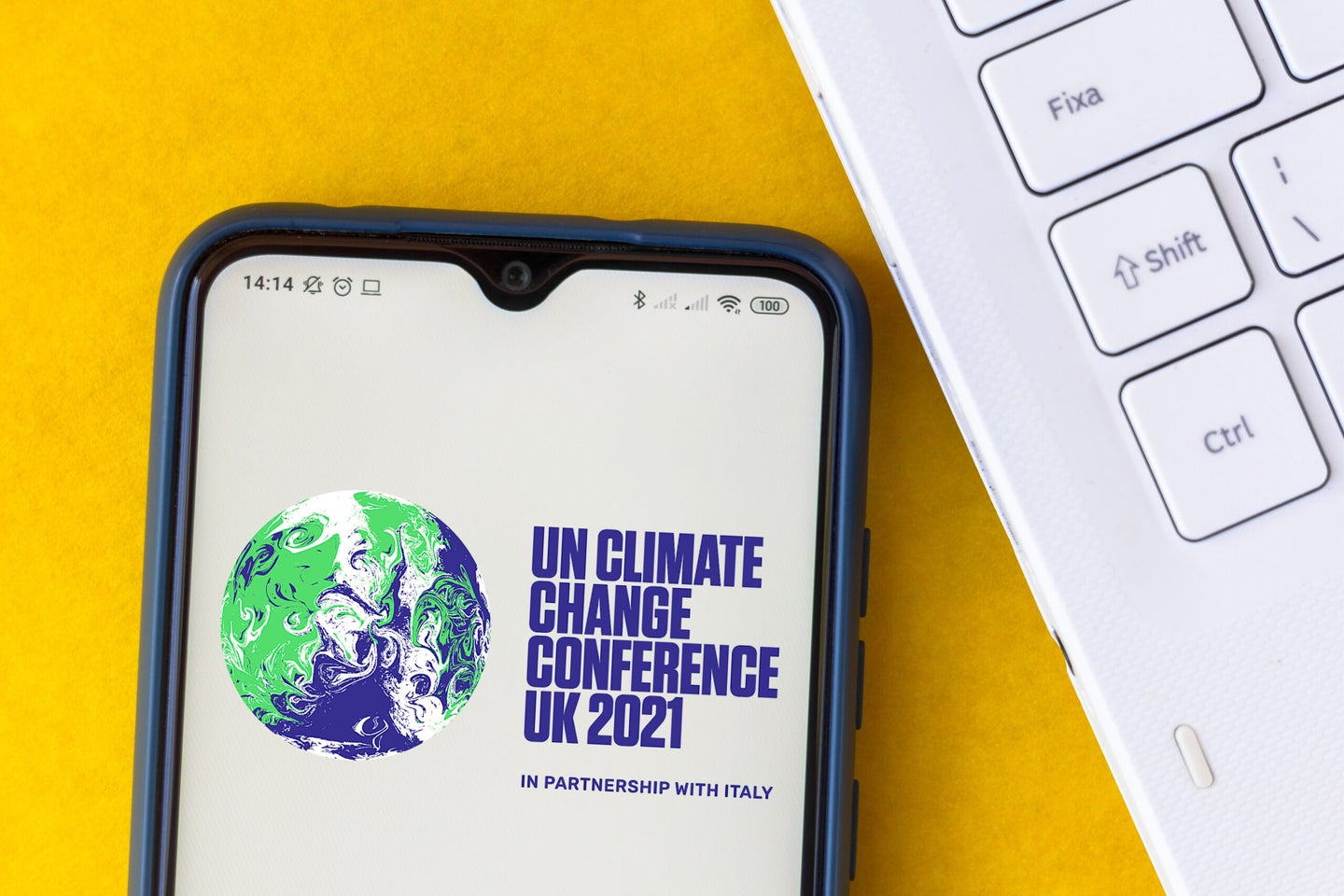 the 2021 United Nations Climate Change Conference (COP26) logo displayed on a smartphone