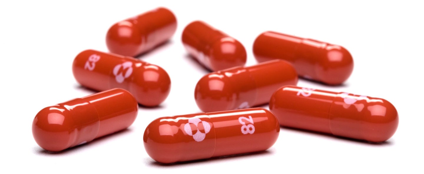 Red capsules on a white background.