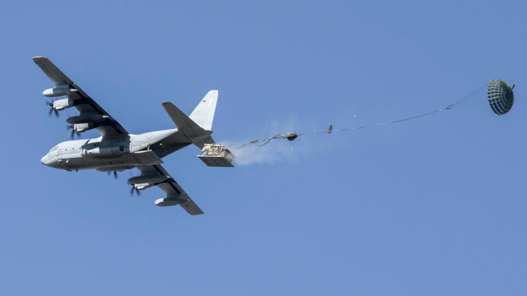 A KC-130J Super Hercules aircraft drops an Infantry Squad Vehicle in Alaska in May, 2021.