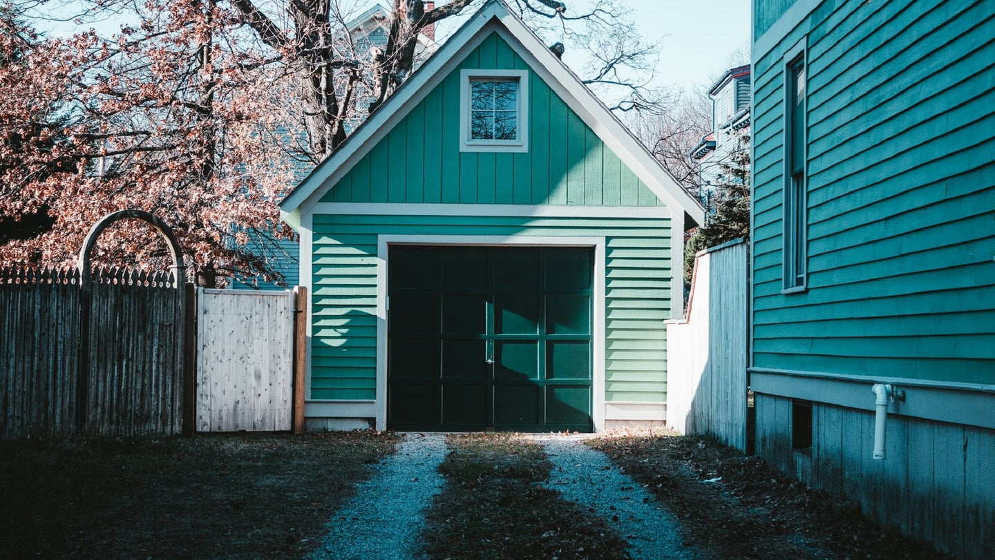 Green garage door next to a Colorado house