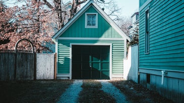 Green garage door next to a Colorado house