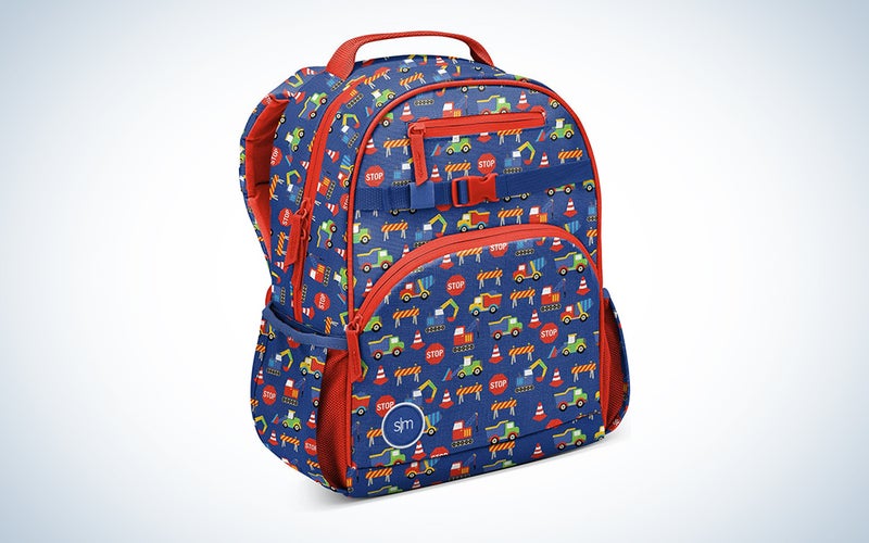 A children's backpack with a construction pattern on it against a blue background.