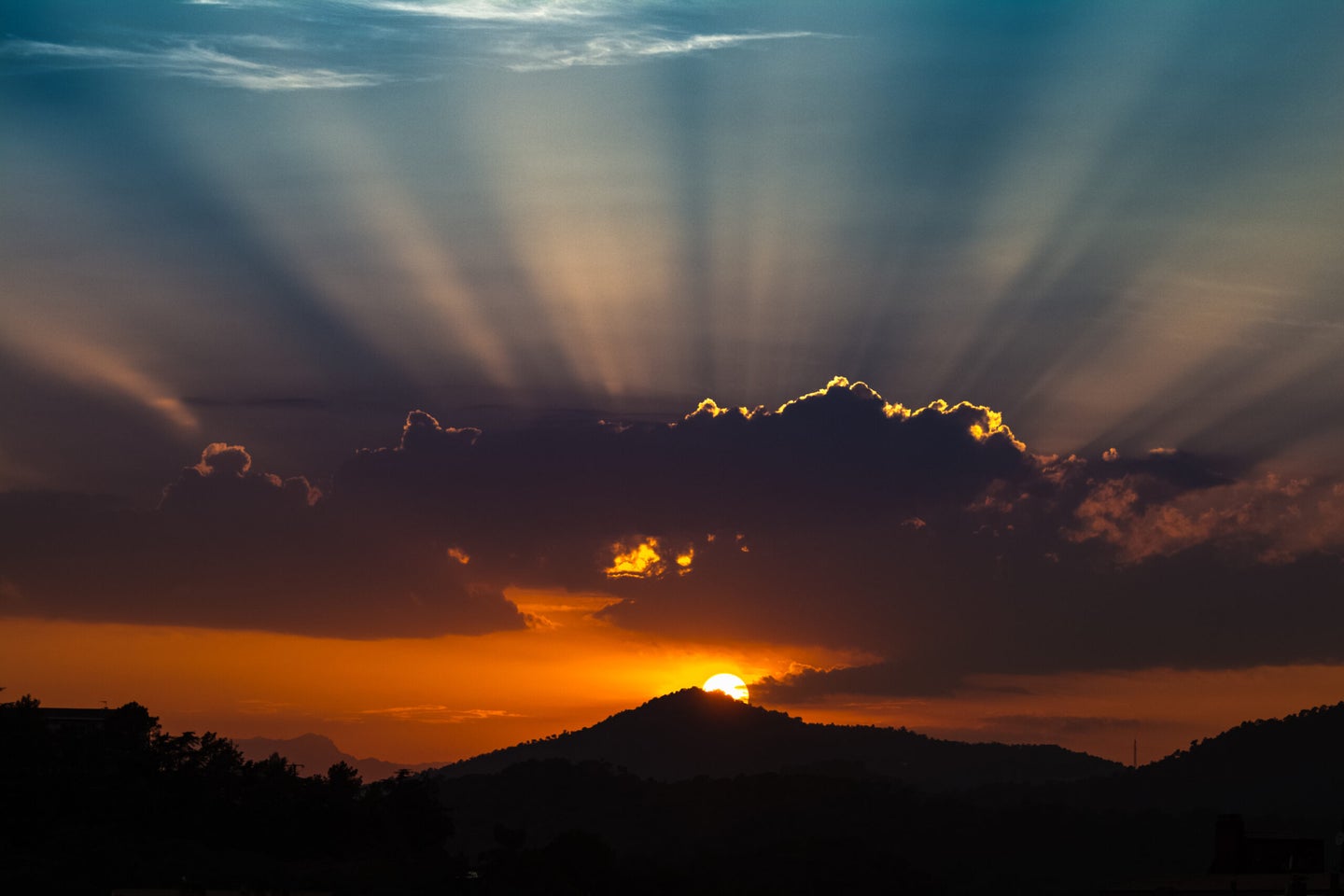 A sun rising over a mountain in Spain.