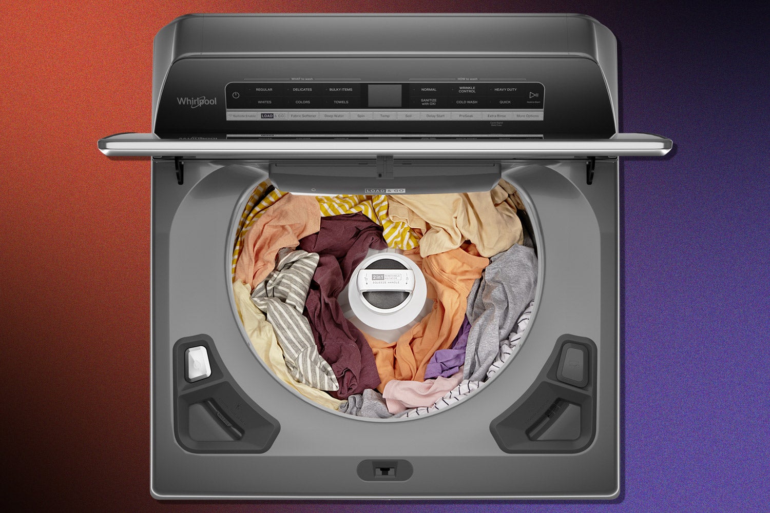 A Whirlpool top-loading washer with a removable agitator, with the agitator in place and full of clothes.