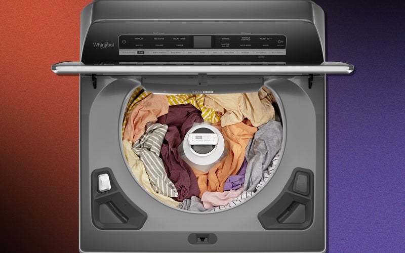 A Whirlpool top-loading washer with a removable agitator, with the agitator in place and full of clothes.