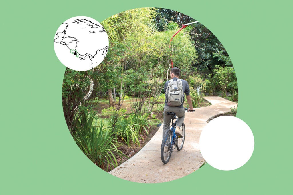 Person on a bike on a biocorridor in Curridabat, Costa Rica, next to map on mint green background