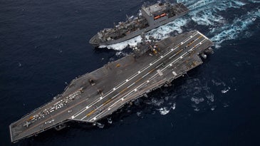 US Navy air craft carrier releasing greenhouse gas emissions over the Pacific Ocean