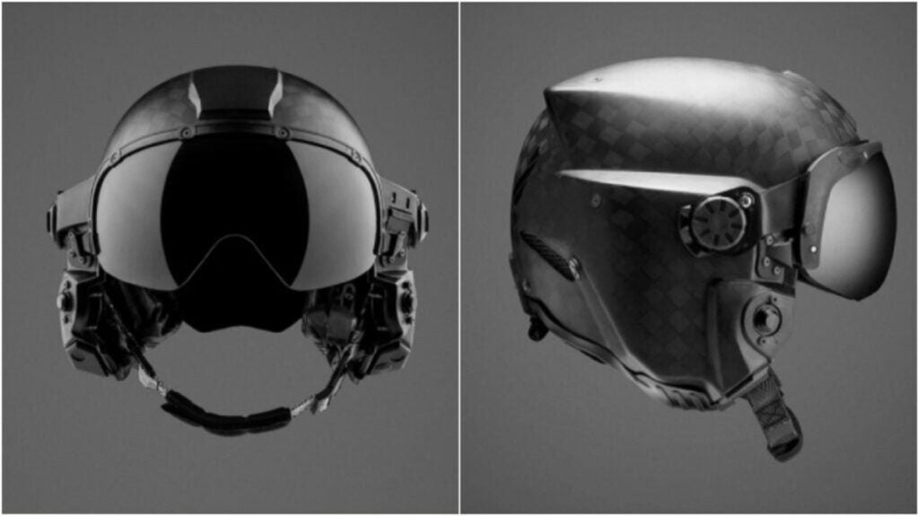 Black checkered Air Force pilot helmet with goggles and chin strap on gray background