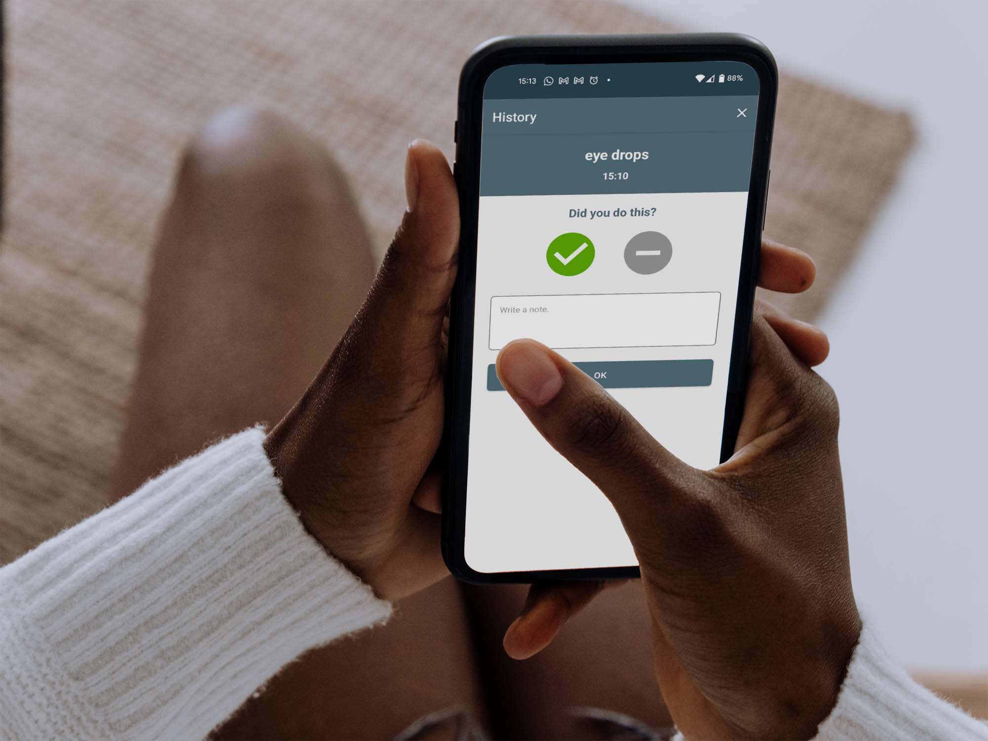 person holding phone with alarm screen going off