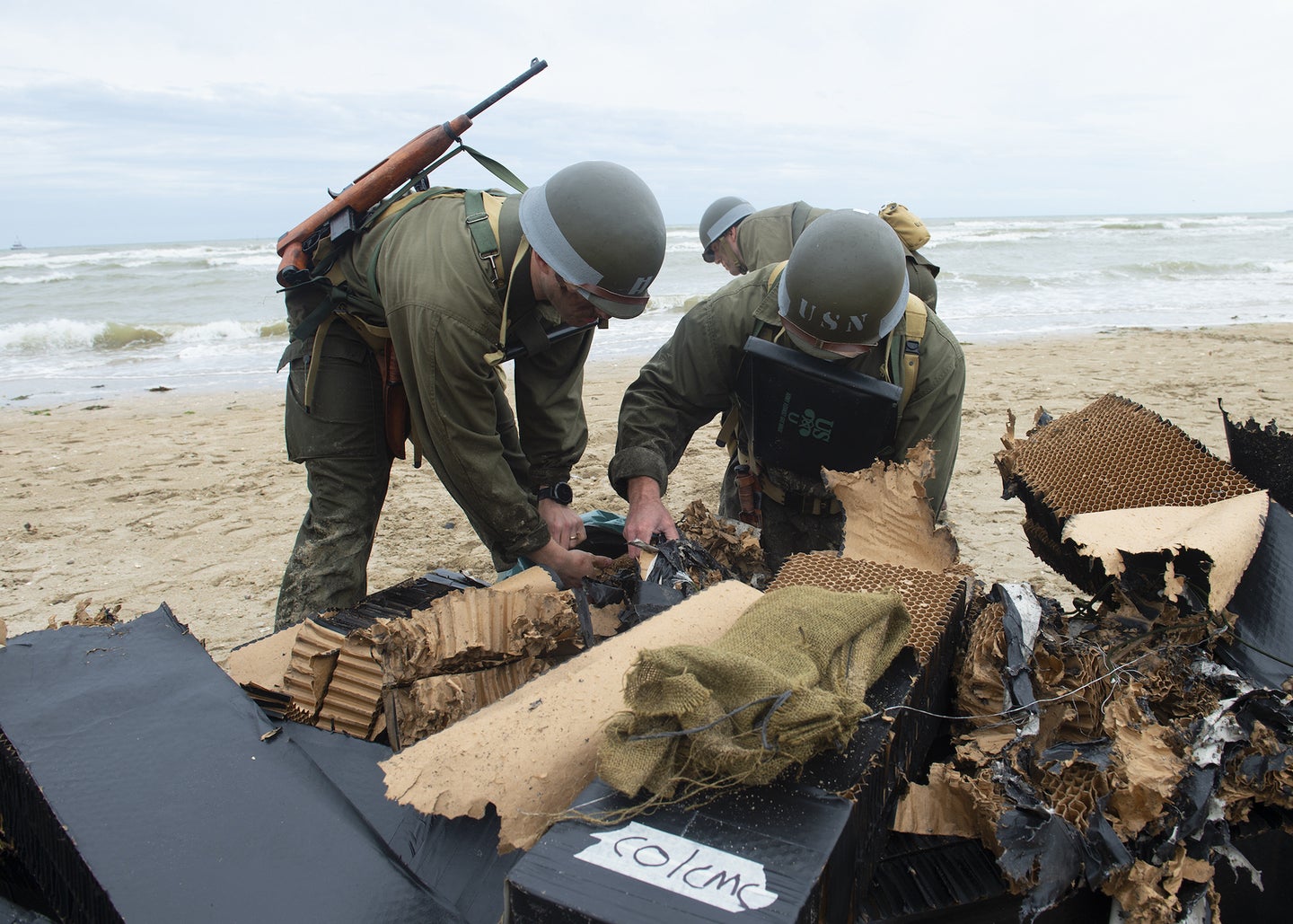 In 2019, Navy SEALs took part in a D-Day reenactment in France, wearing gear from the time period and cleaning up debris afterwards.