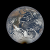 planet earth with a rounded black shadow creeping over its southern pole 