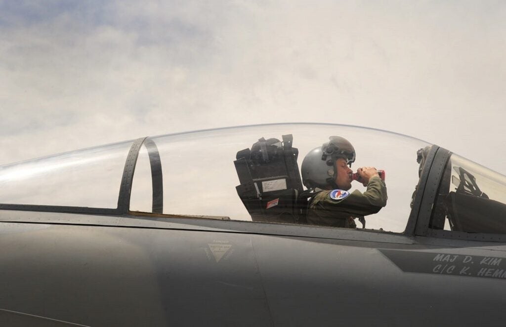 National Guard squadron pilot drinks Gatorade from the cockpit during a training mission