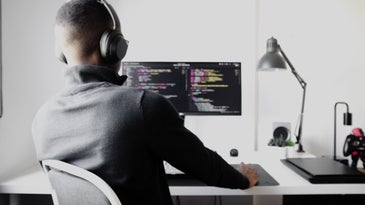 man coding at desk