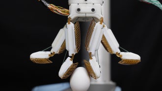 robot fingers grabbing egg