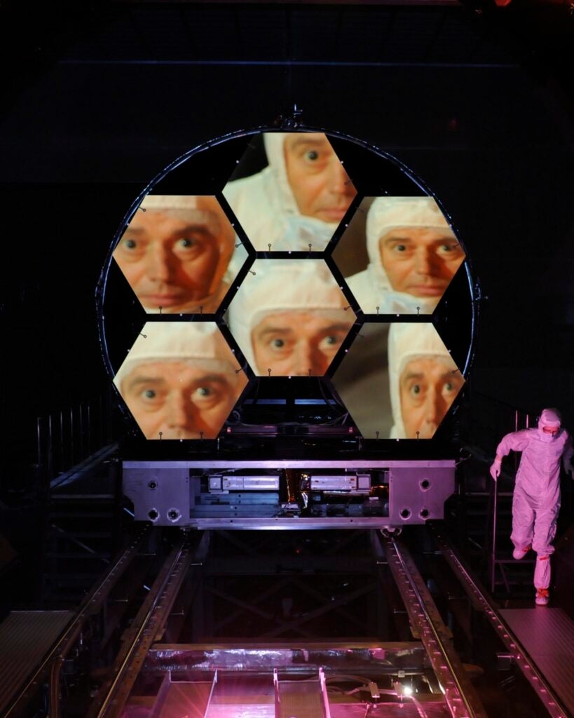 James Webb Space Telescope project scientists' face reflected in five hexagonal mirrors