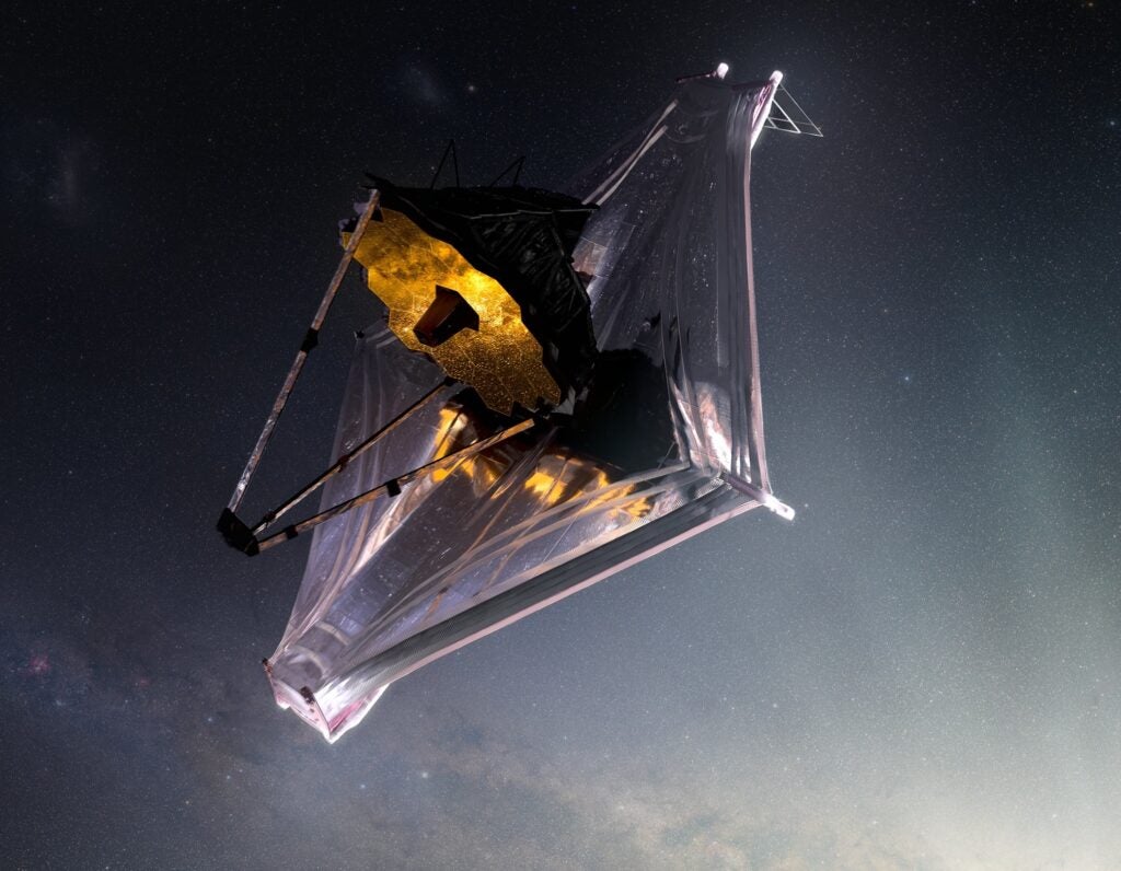 James Webb Space Telescope in flight with mirrors and sunshield unfurled in an artist's rendering
