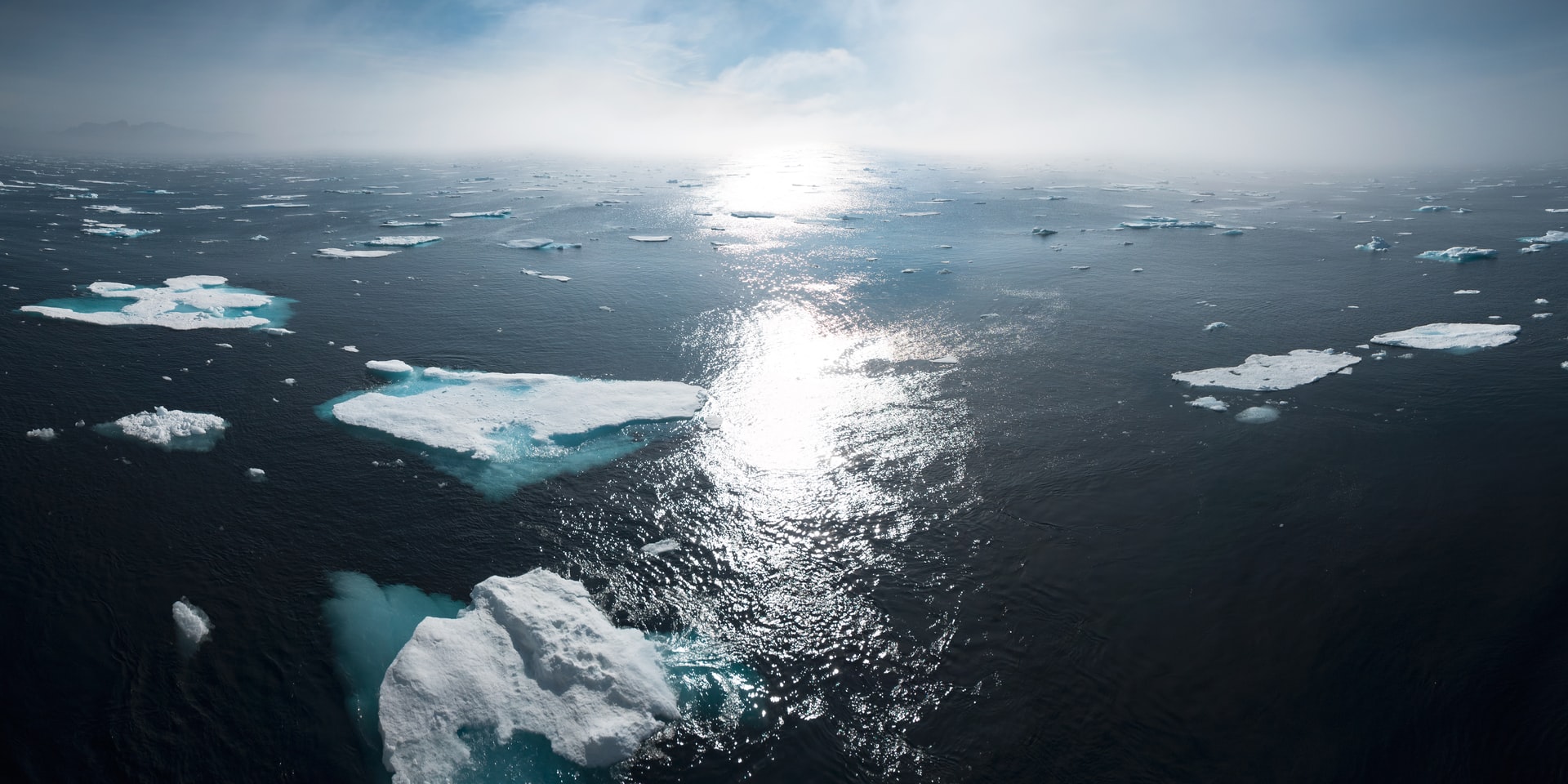 the ocean near greenland with chunks of ice