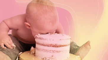 a baby puts their face in a frosted cake
