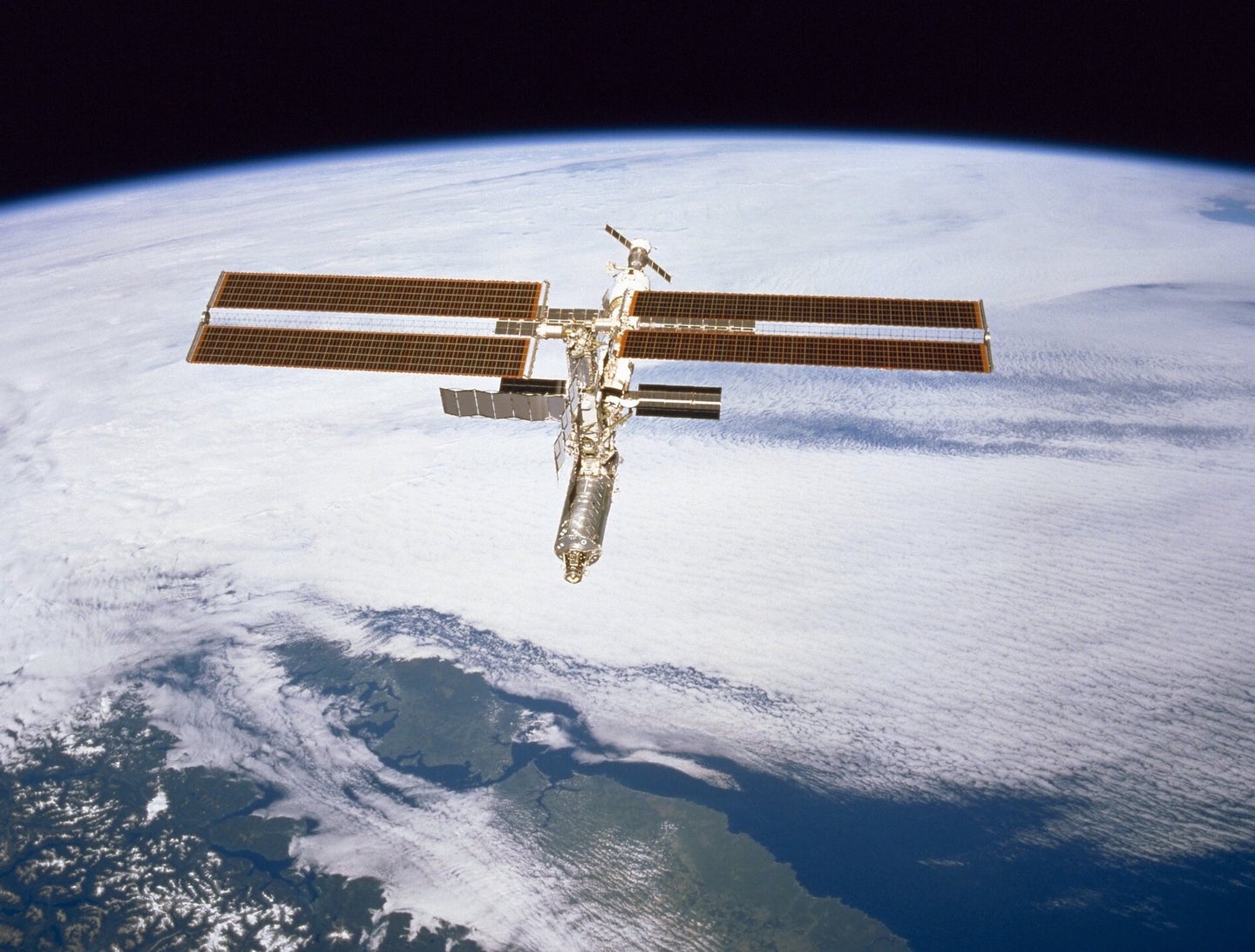 International Space Station now extended to 2030 in the Earth's lower orbit over clouds and South America