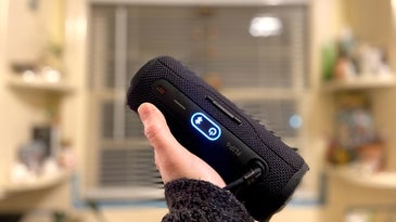 Black JBL Flip 6 Bluetooth party speaker held in the author's hand