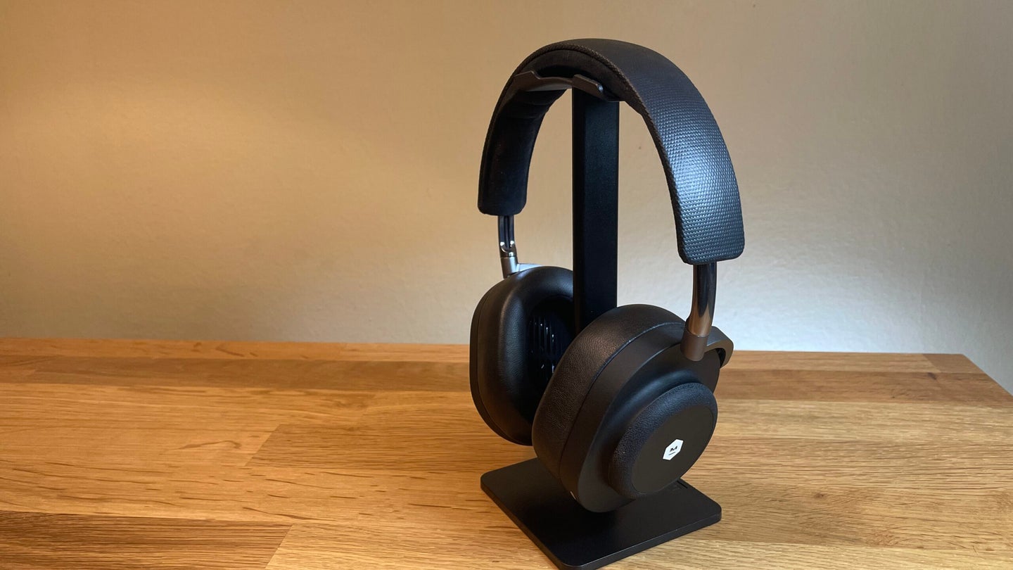 The Master & Dynamic MG20 headphones on a stand at an angle