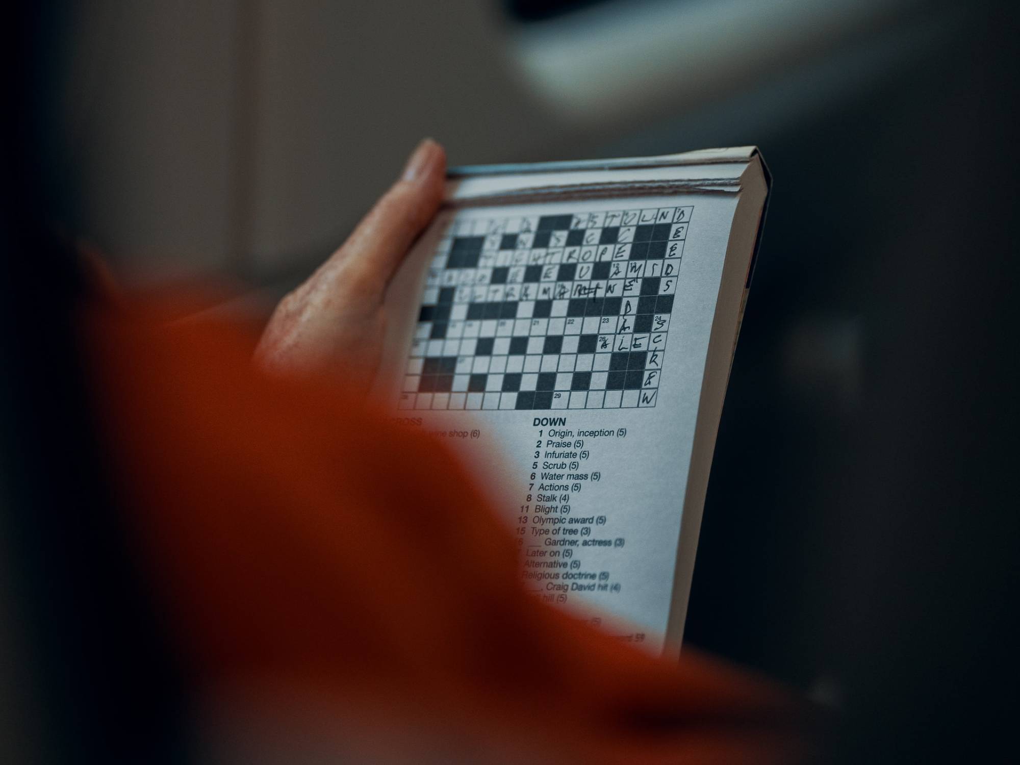 person doing crossword puzzle