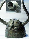A rusty helmet with long twisting horns