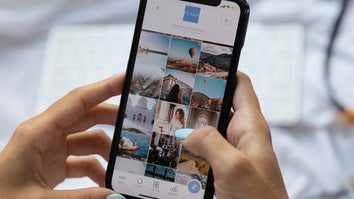 hands holding phone with photos on screen