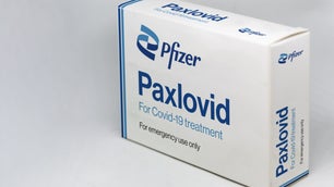 a white and blue box of paxlovid covid pills, with the pfizer logo