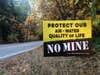 Yellow and black environmental protest lawn sign that says No Mine