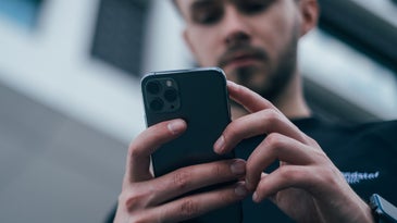 Person holding phone looking at screen
