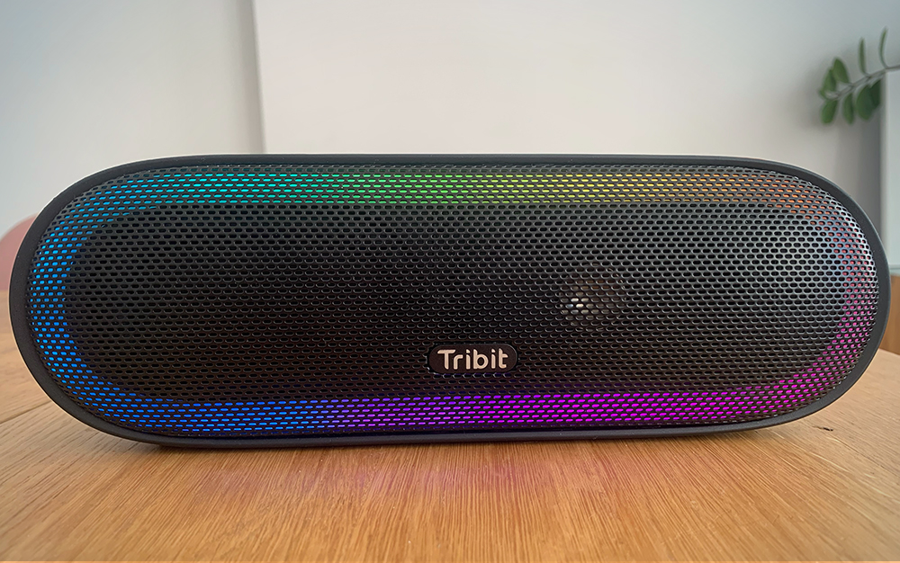 Tribit Speaker on a wooden table.