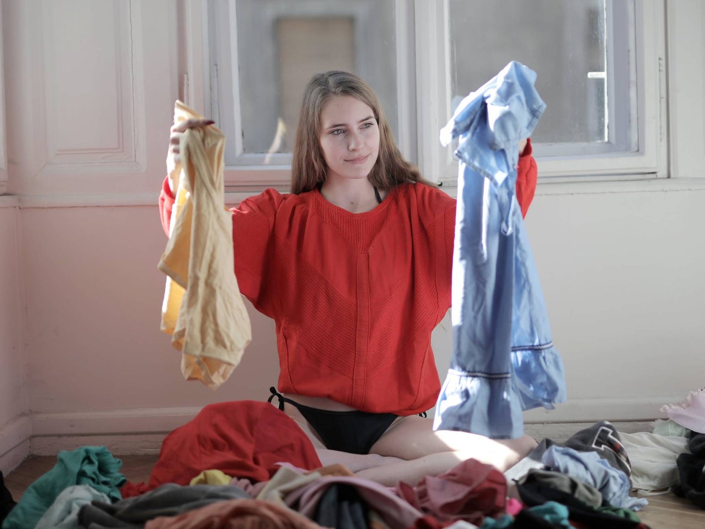 person on the floor sorting laundry