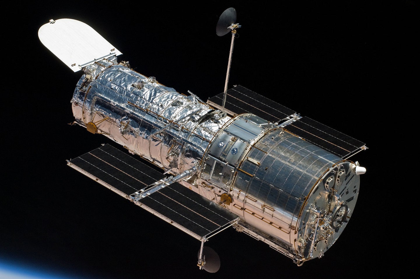 Hubble Space Telescope in orbit while photographing distant galaxies and invisible black holes
