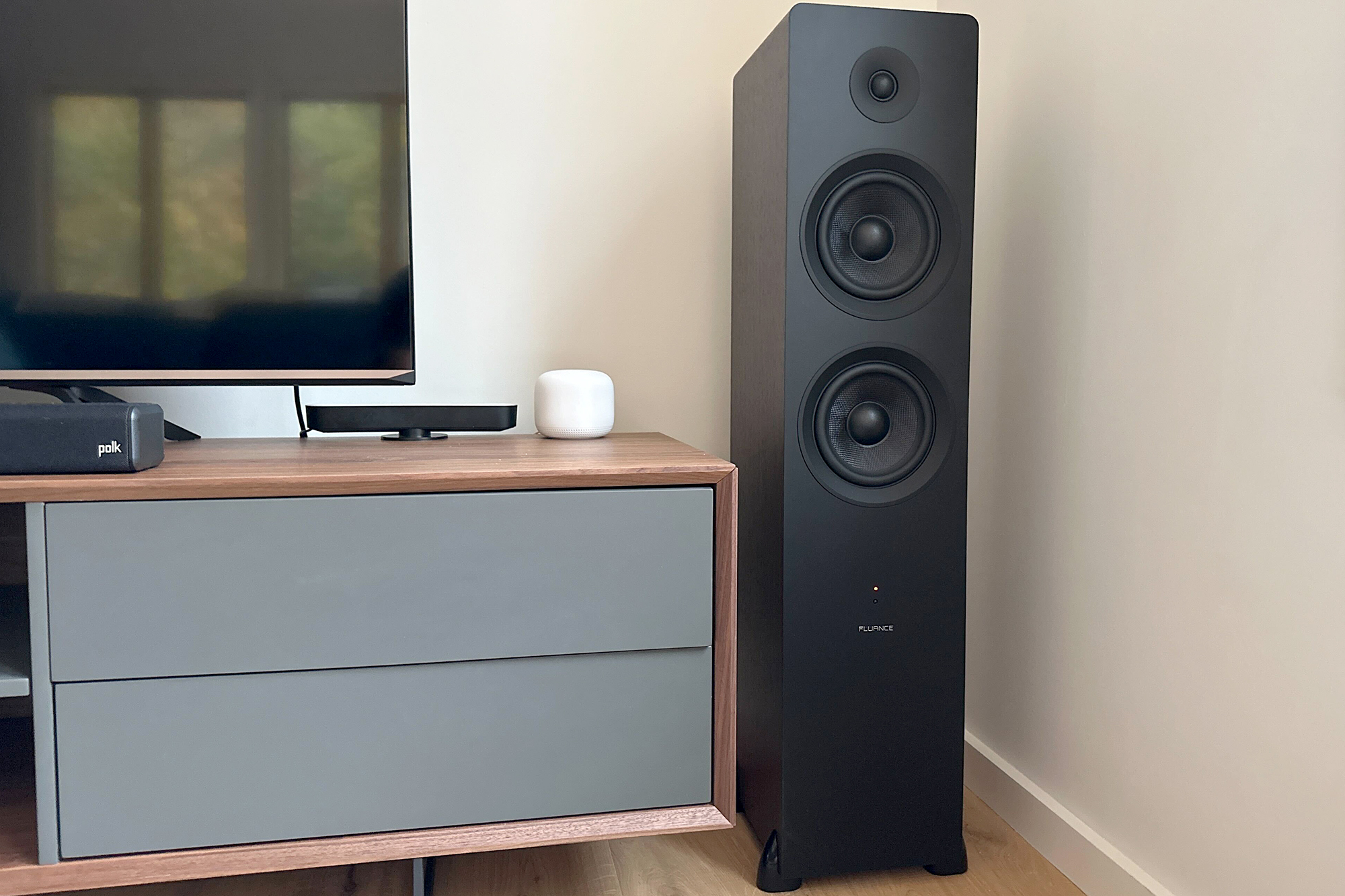 Fluance Ai81 floorstanding speakers next to a TV in Billy's living room