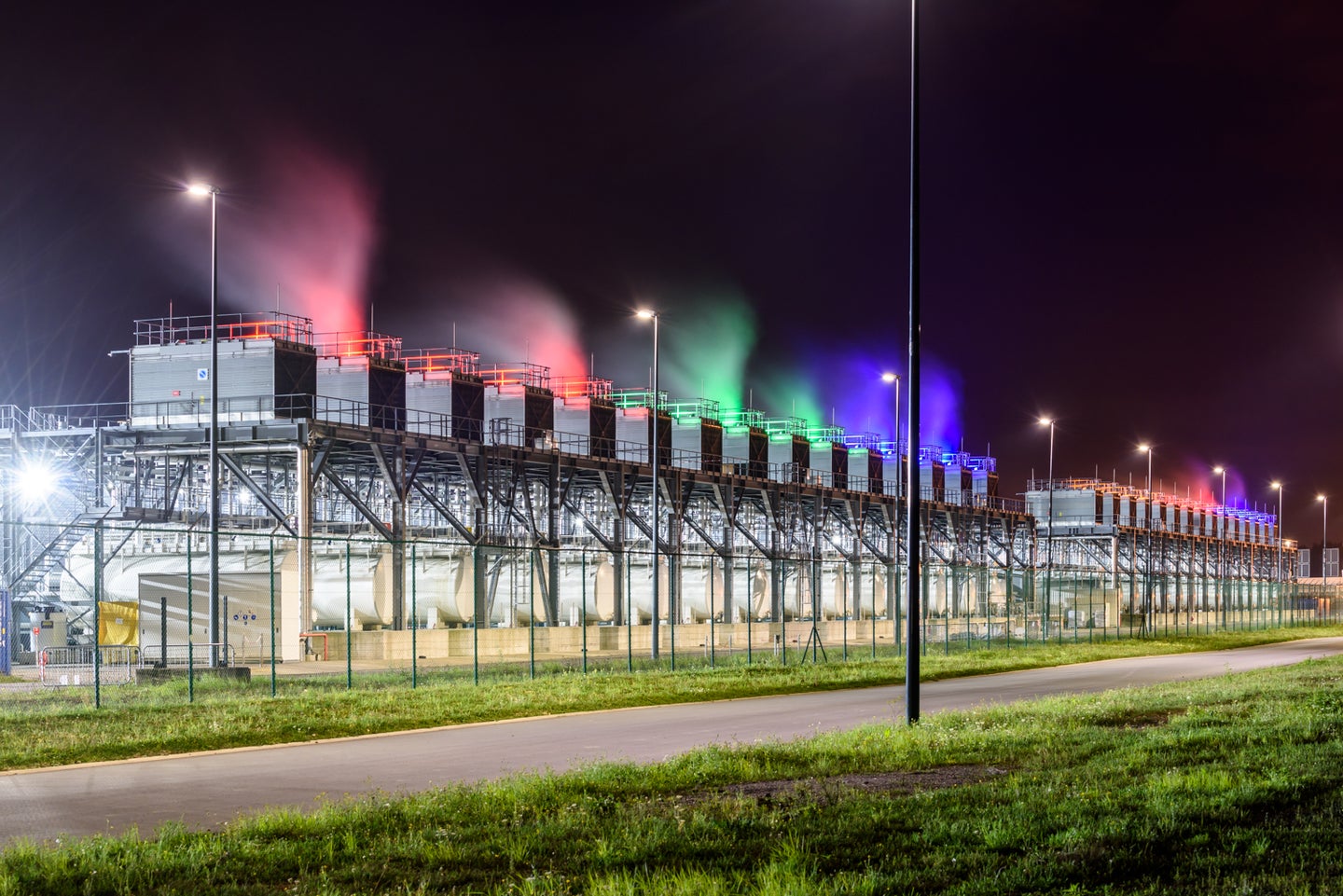 Google data center and server farm in St. Ghislain, Belgium, with cooling towers lit up at night