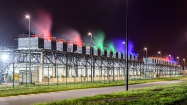 Google data center and server farm in St. Ghislain, Belgium, with cooling towers lit up at night