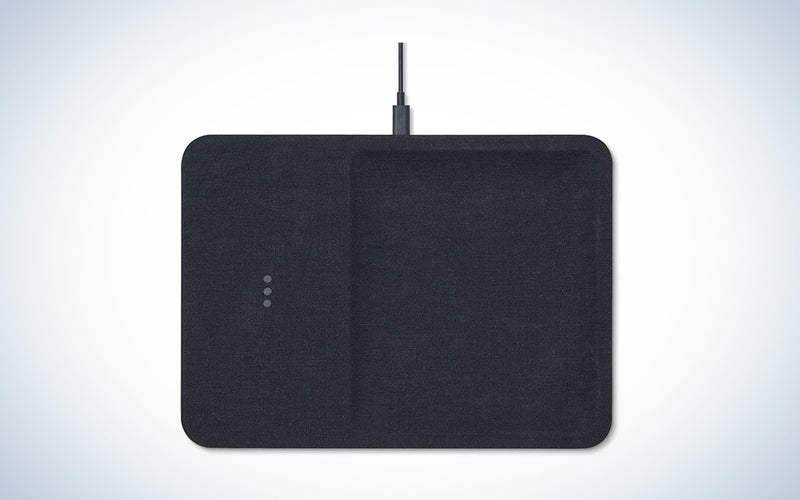 A charcoal linen wireless charging station on a blue and white background
